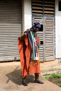 Man wears colorful traditional Nigerian attire outdoors in Jos, Nigeria.
