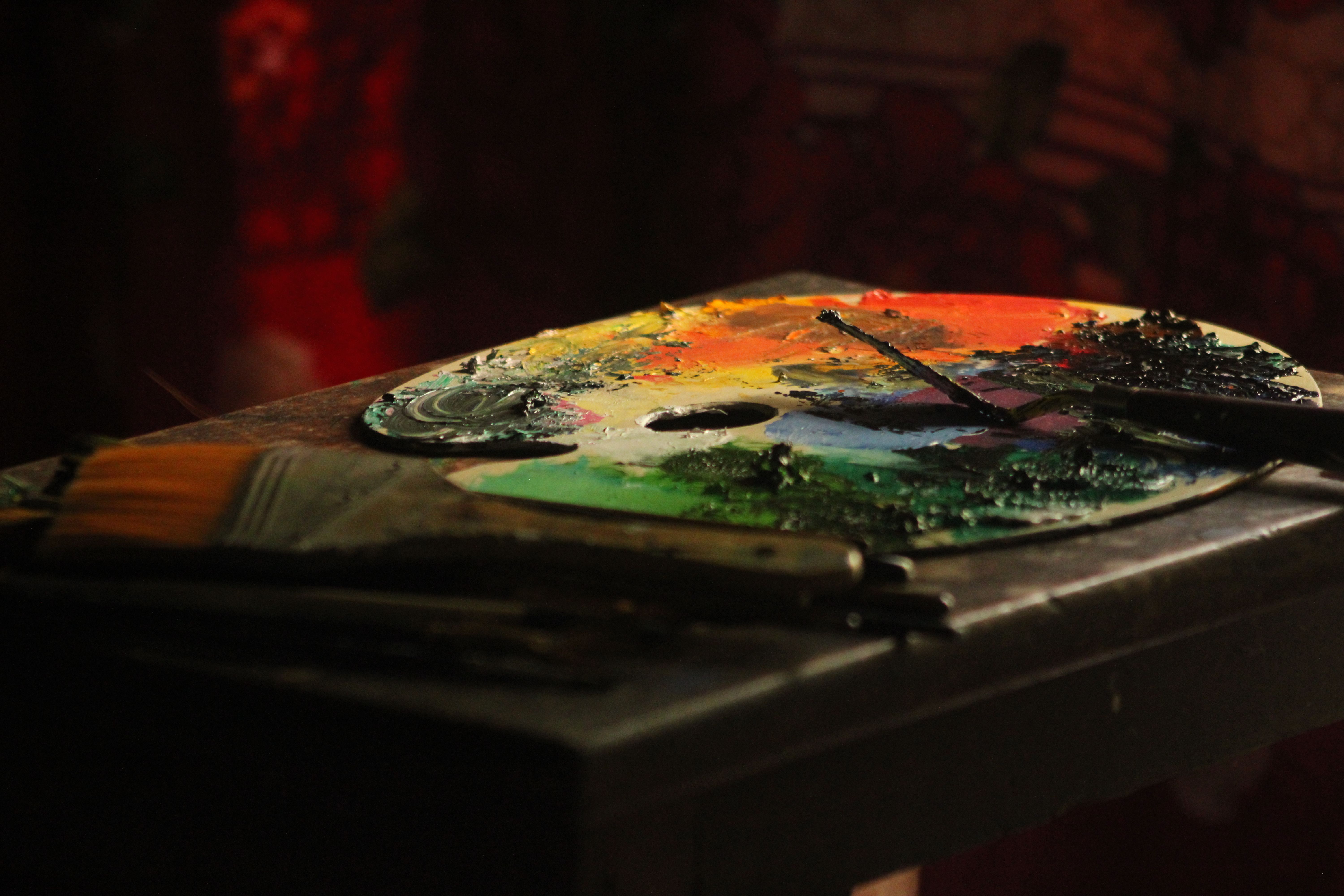 Colorful paint palette with brushes in a warm, artistic atmosphere.. colorful, paint, palette