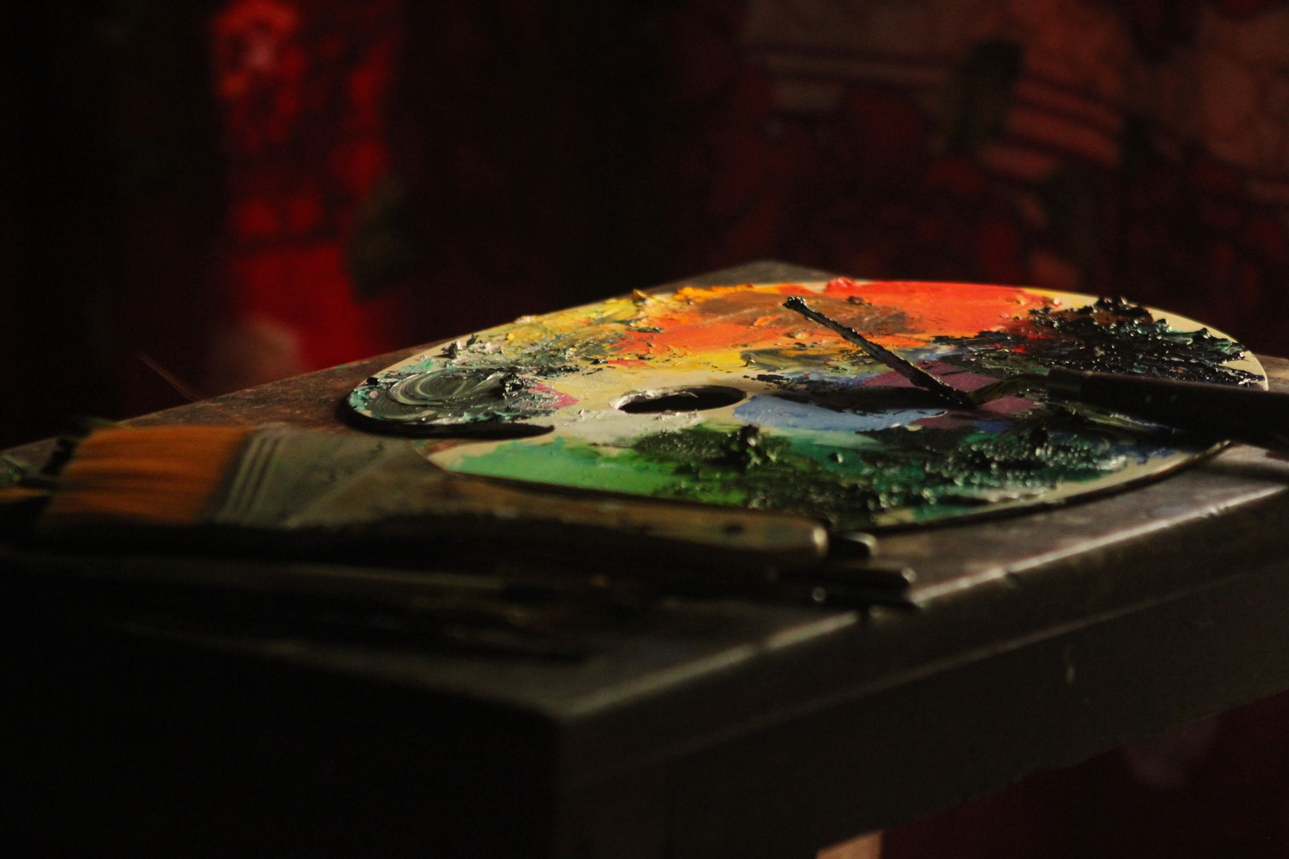 Colorful paint palette with brushes in a warm, artistic atmosphere.. colorful, paint, palette