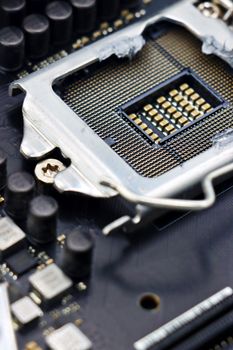 Detailed close-up of a CPU socket on a computer motherboard, highlighting the intricate components and circuitry.