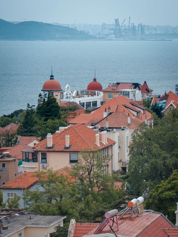 A scenic coastal town with red roofs and sea view