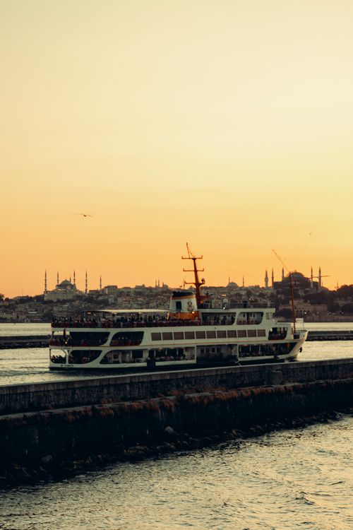 Free Scenic ferry ride on Istanbul's Bosporus at sunset with iconic skyline Stock Photo
