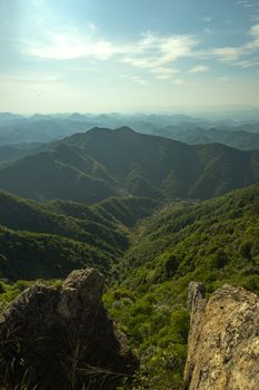 Breathtaking view of mountainous landscape with lush green valleys under a clear sky.