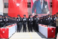 Group of Turkish police officers in uniform saluting at an official ceremony in Yozgat, Türkiye.
