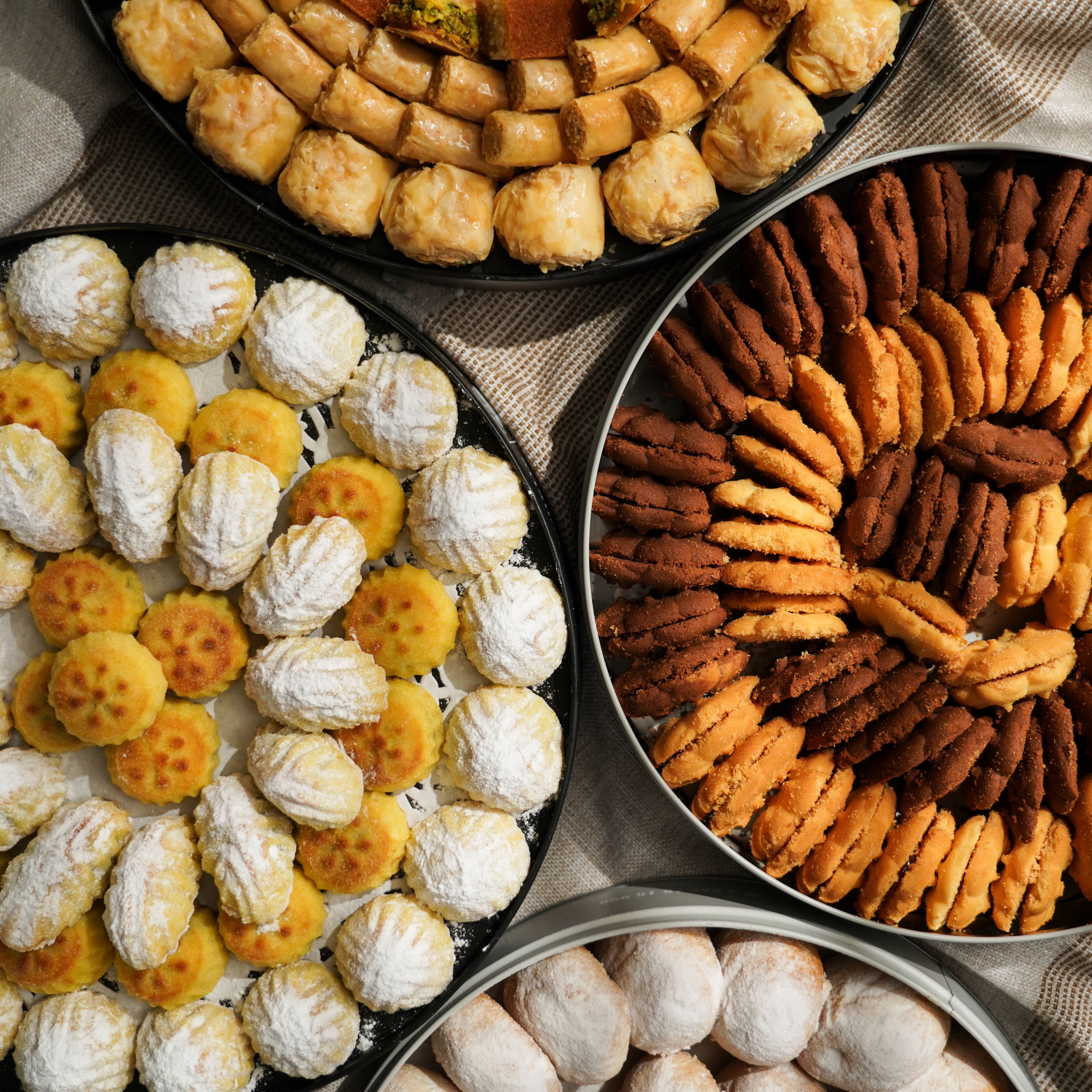Cookies stacked on a cooling rack near flour dust