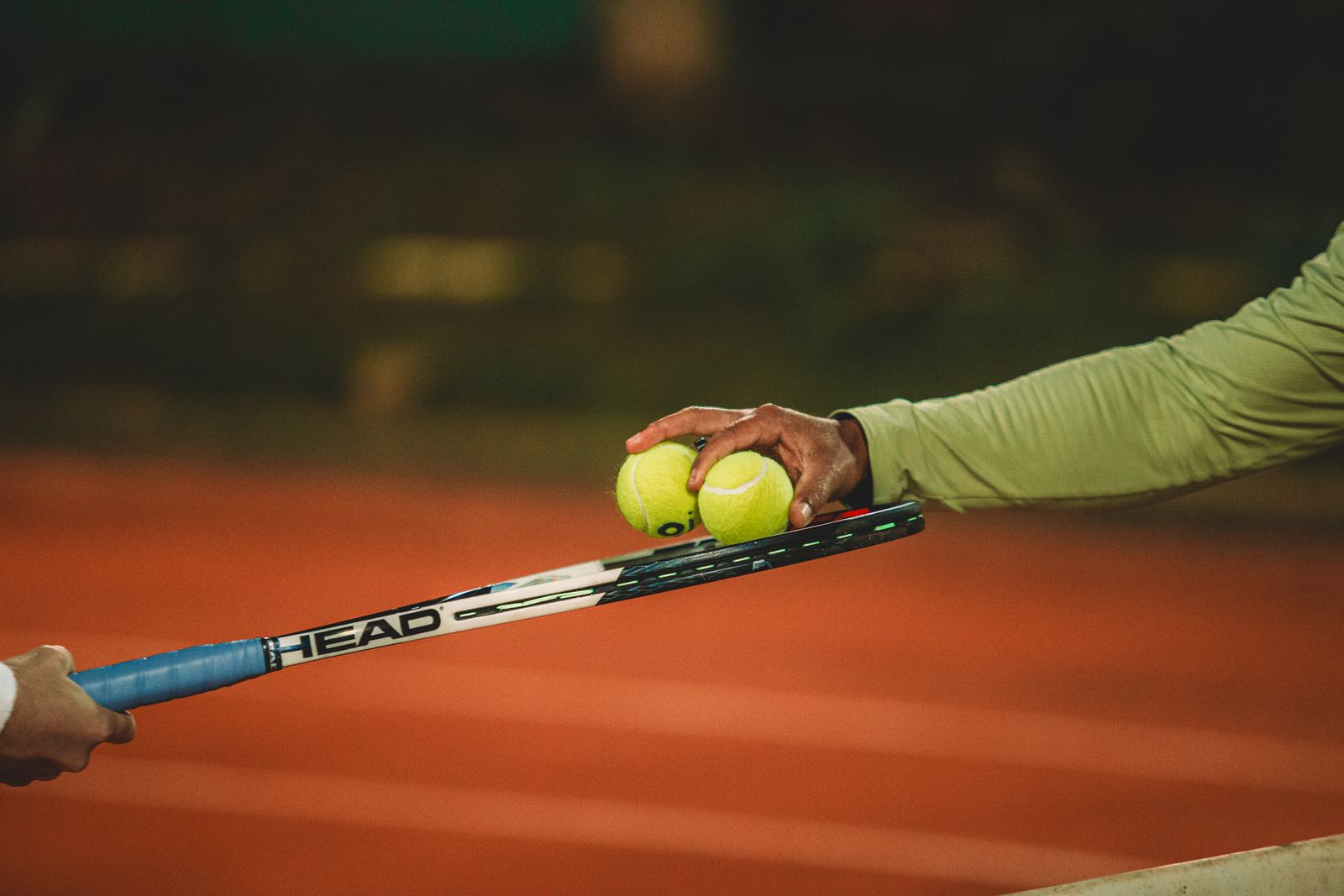Tennis interaction on clay court at night