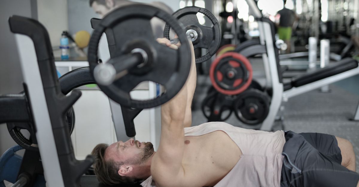 Bench press training in a gym, relevant to choosing an elbow sleeve for pressing