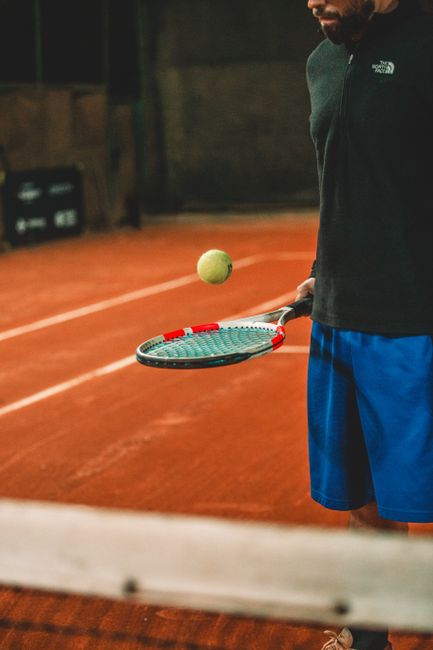 Christian Harrison on court demonstrating his tennis player resilience during a match.