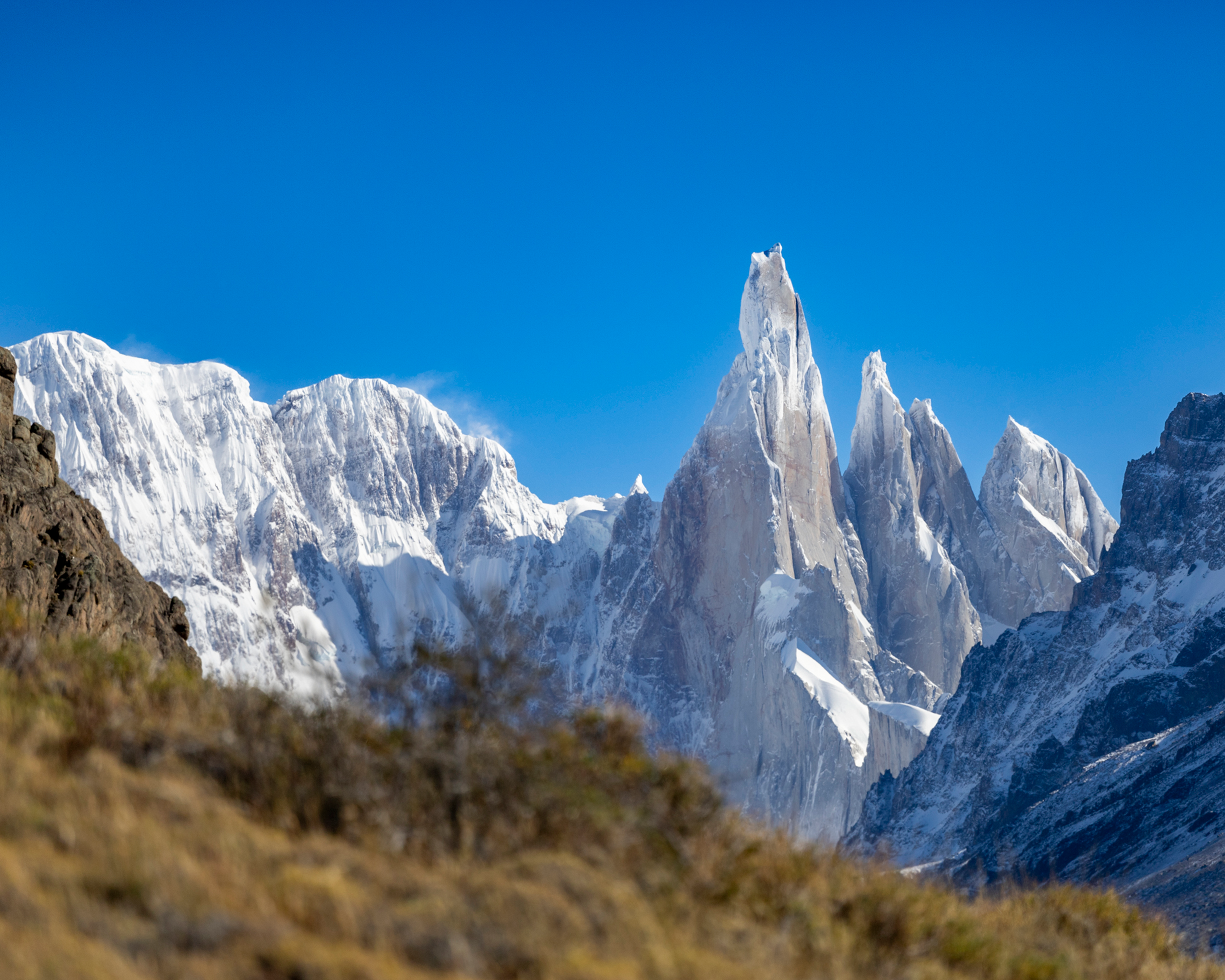 Majestic Cerro Torre peaks under clear blue skies in El Chaltén, Argentina.