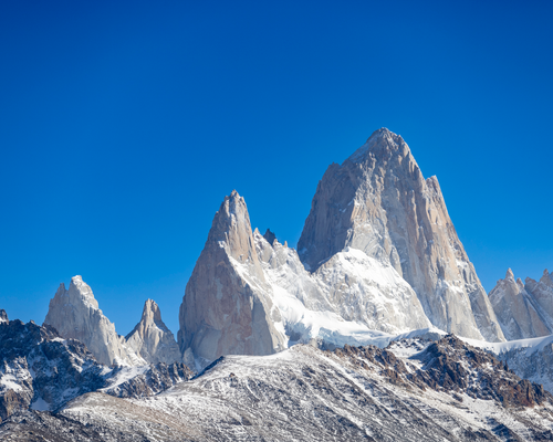 Free Breathtaking view of the snow-capped Fitz Roy mountains under a clear blue sky in El Chalten, Argentina. Stock Photo
