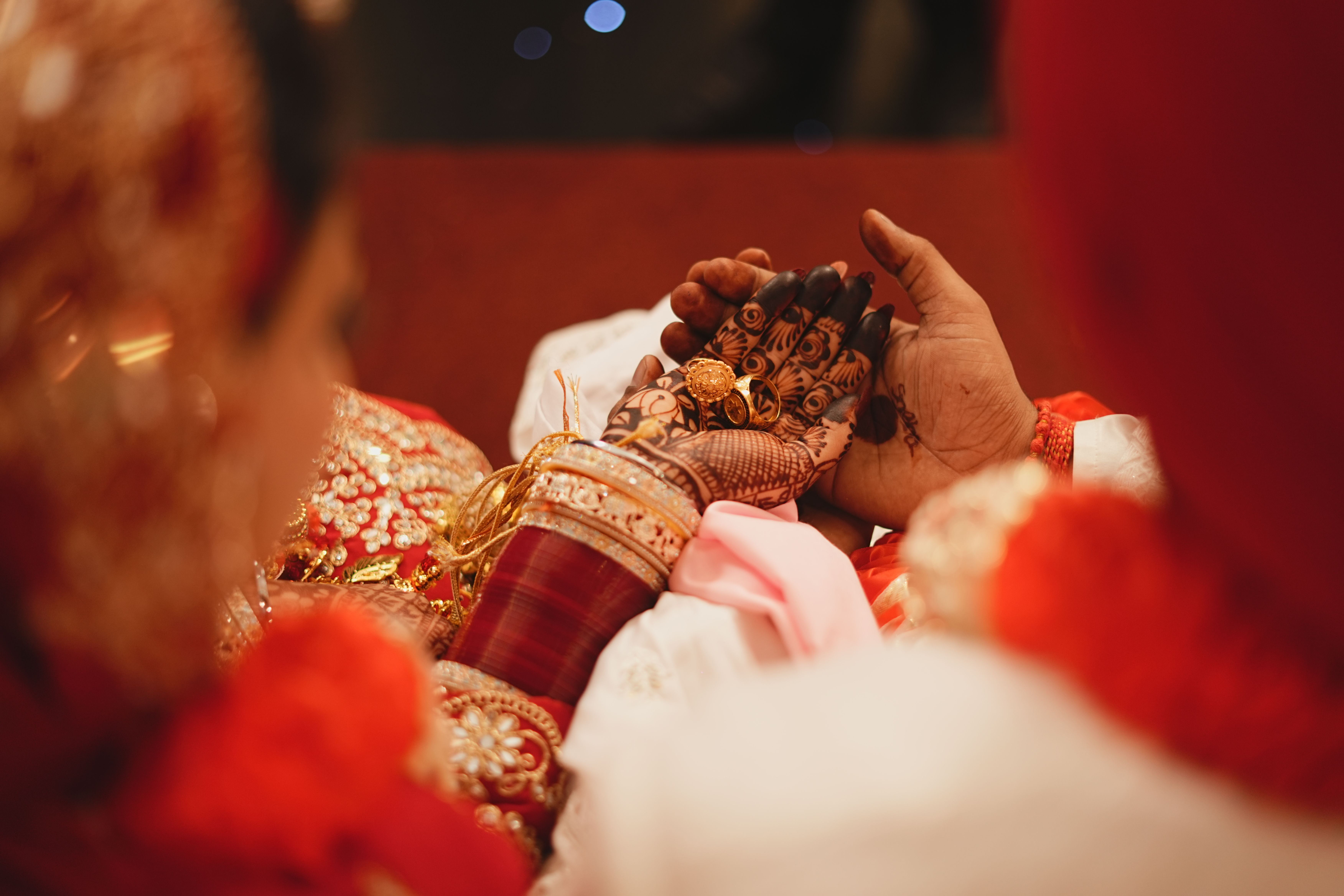 Bridal hands adorned with mehndi during an Indian mehendi ceremony