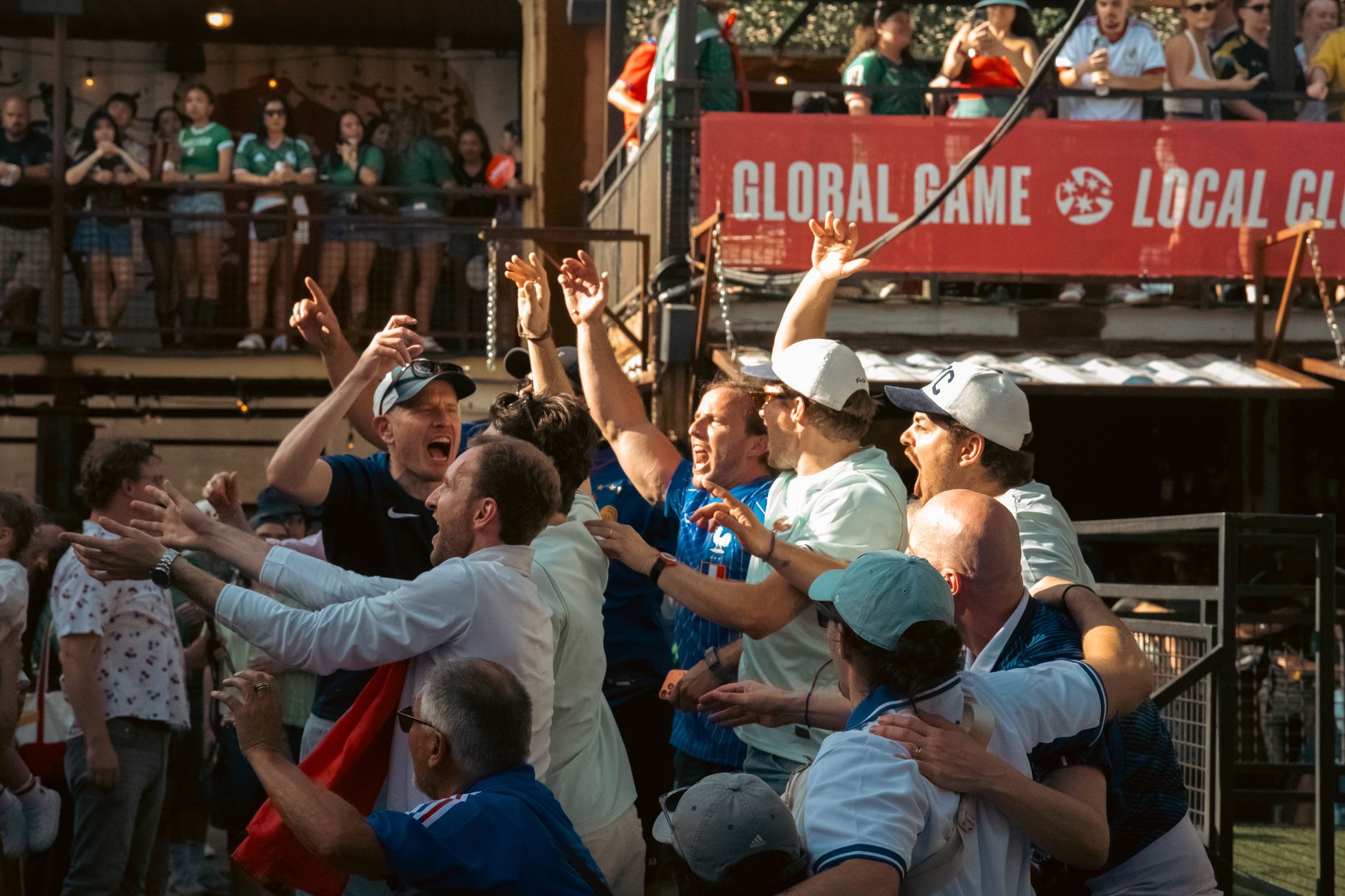 Excited sports fans celebrating a victory at an outdoor Chicago event, embodying joy and enthusiasm.