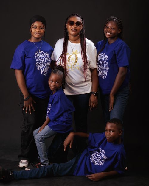 Free Family posing for birthday in matching shirts, cheerful mood Stock Photo