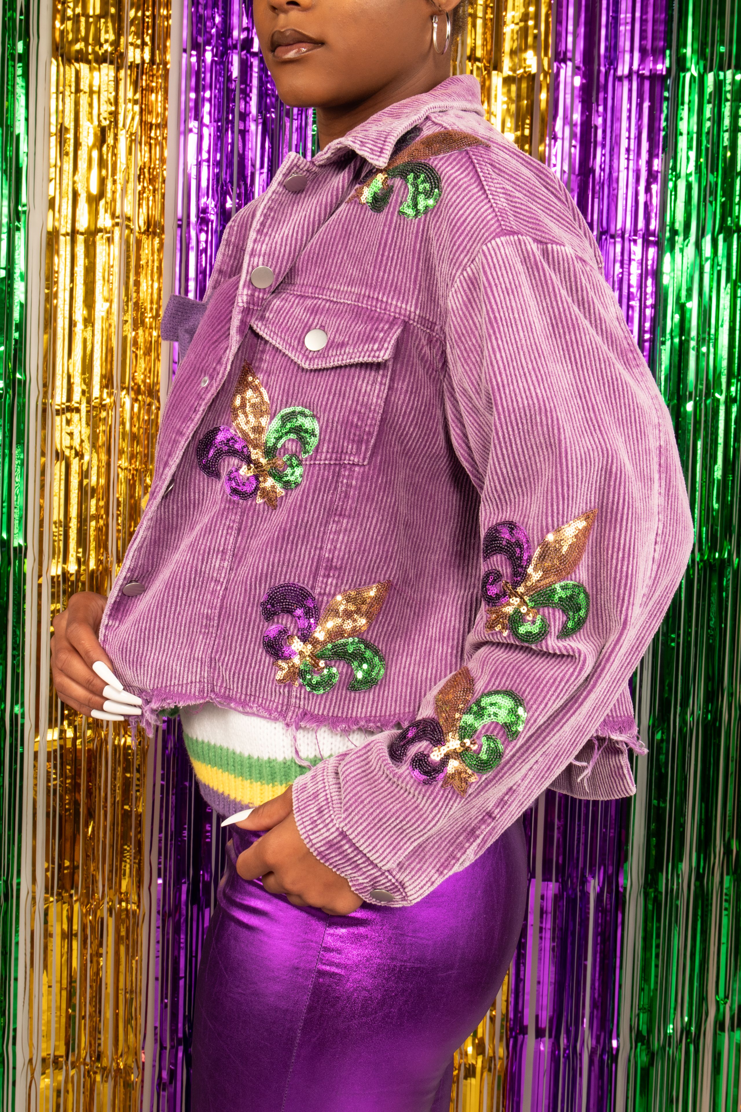 Colorful Mardi Gras outfit with fleur-de-lis in Mobile, Alabama celebration.
