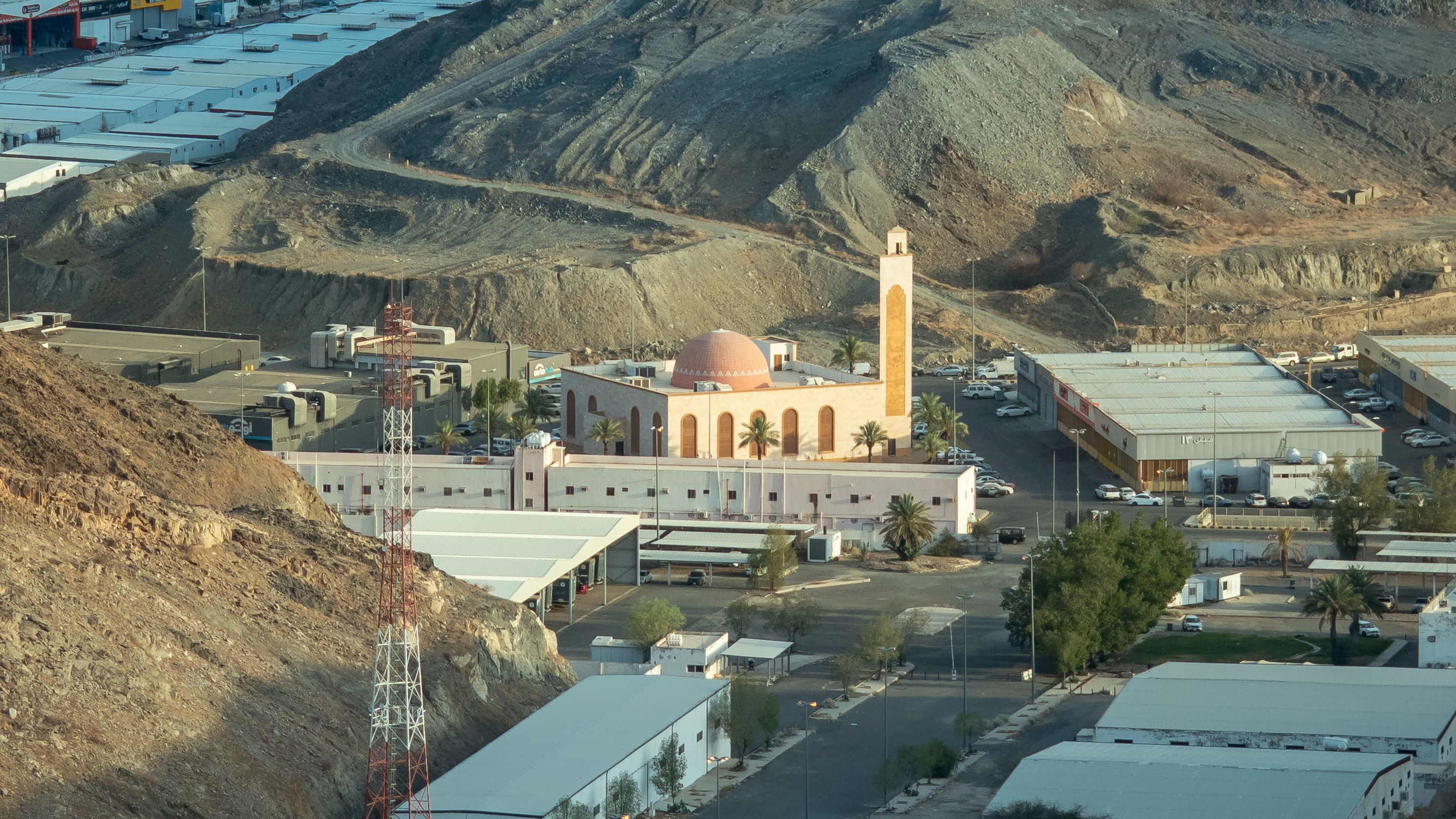 Aerial view of a mosque nestled in the rocky mountains of Makkah, Saudi Arabia.