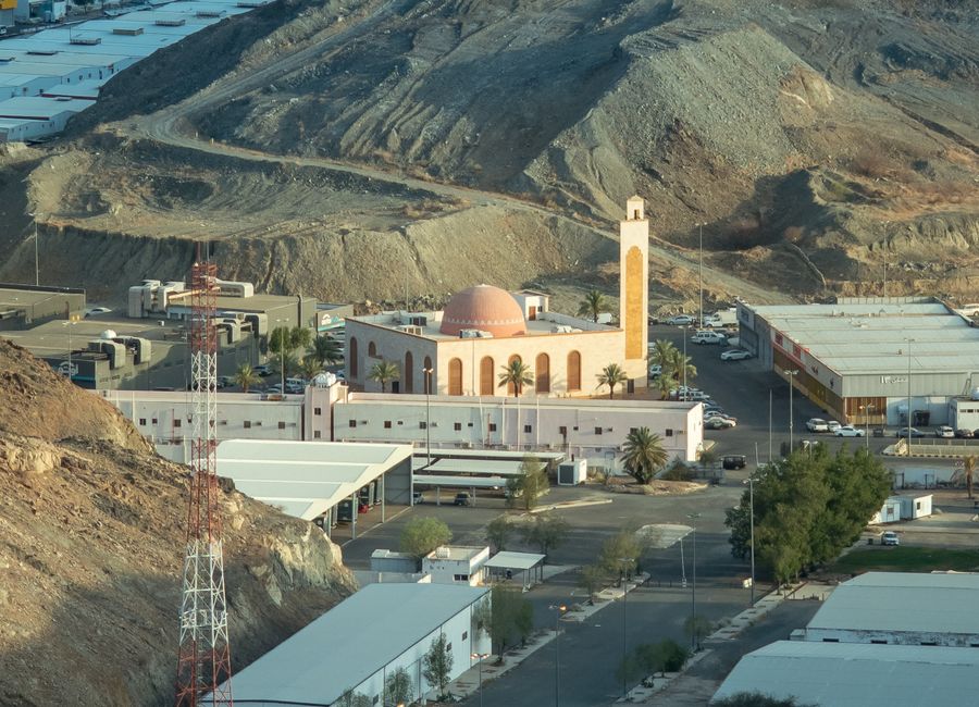 Aerial view of a mosque nestled in the rocky mountains of Makkah, Saudi Arabia.