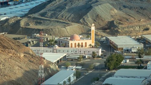 Free Aerial view of a mosque nestled in the rocky mountains of Makkah, Saudi Arabia. Stock Photo