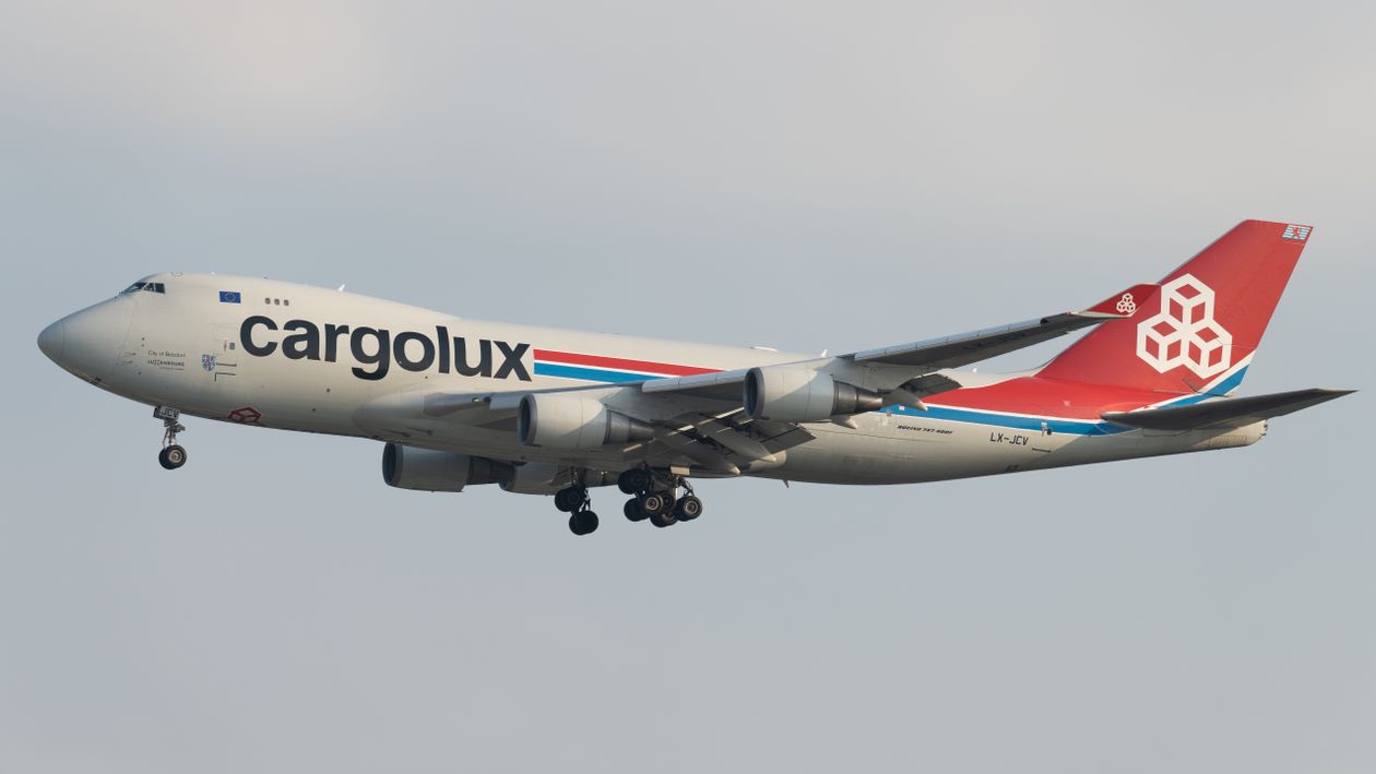 Large cargo aircraft in flight above the clouds