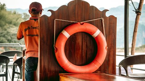 Free A travel guide with a vibrant lifebuoy aboard a boat in Luang Prabang, Laos. Stock Photo