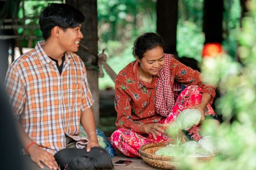 Free A mother and son engage in vegetable preparation at home, fostering family connection and tradition. Stock Photo