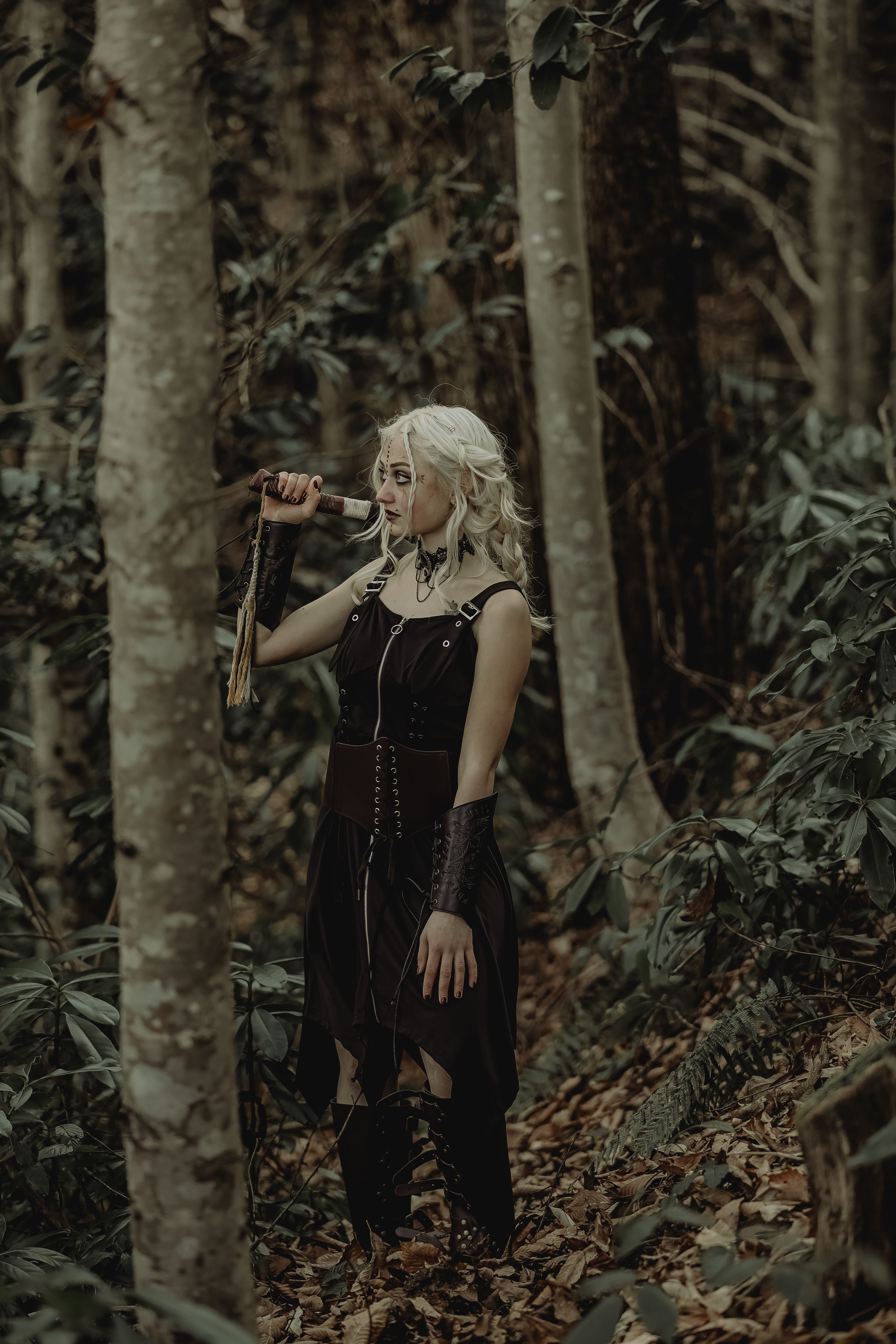 Fantasy character holding a sword in a forest