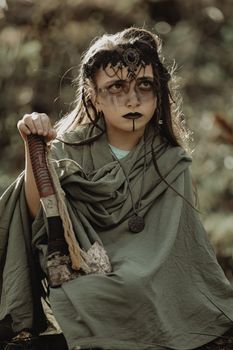 Captivating fantasy portrait of a child dressed as a warrior with detailed makeup and axe.