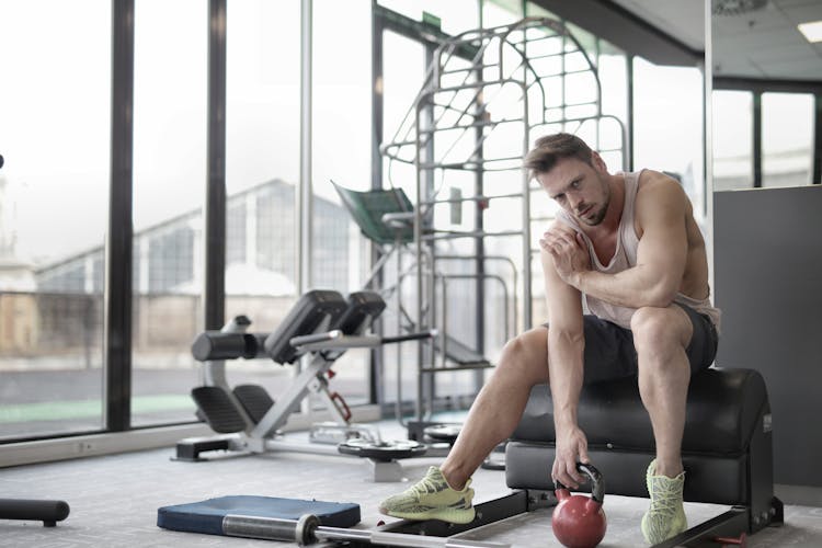 Man Touching A Kettlebell