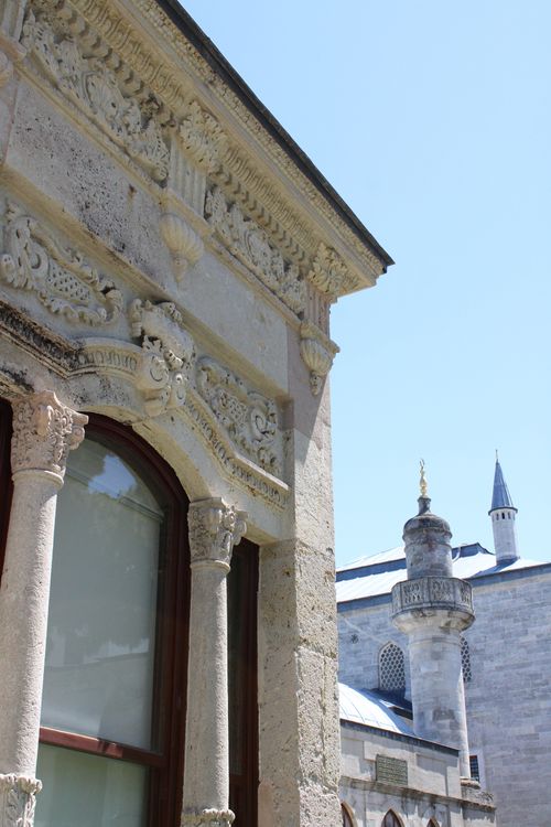 Free A detailed view of ornate Ottoman architecture alongside a mosque under a clear sky. Stock Photo
