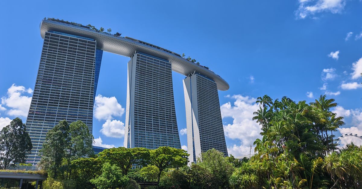 A futuristic city skyline with blockchain symbols integrated into the buildings