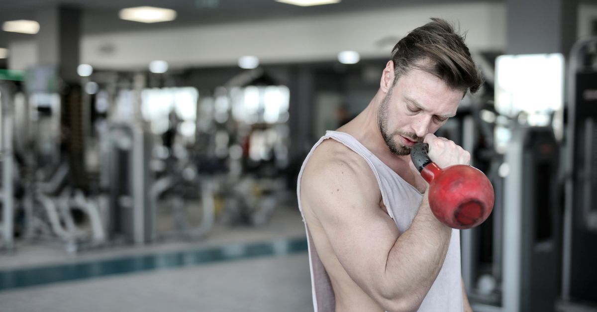 Man holding kettlebell in gym