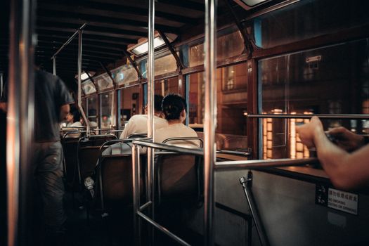 A cozy nighttime tram journey through the streets of Hong Kong, capturing urban life.