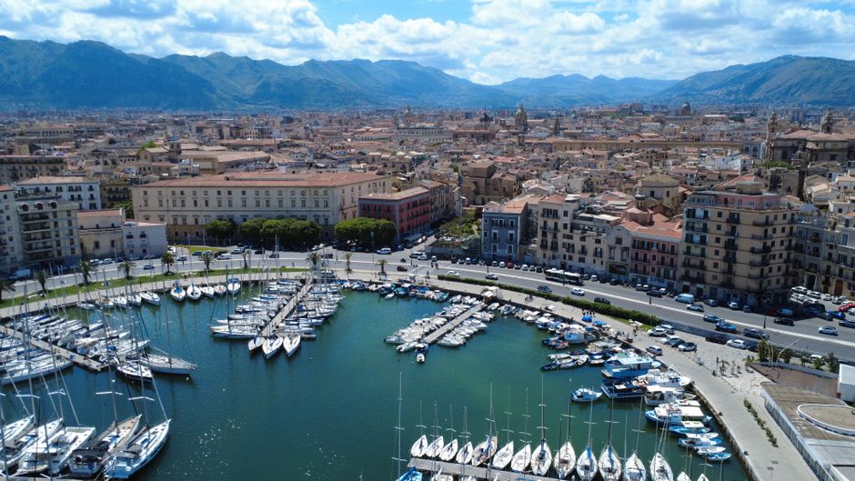 Unforgettable Capri Signature Boat Tour from Amalfi with Time on Land Review 2026 - A scenic aerial view of Palermo Marina with surrounding cityscape and mountains in the background.