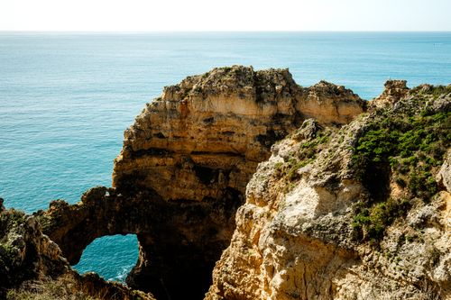 Free Breathtaking view of the coastal cliffs in Algarve, Portugal with clear blue water. Stock Photo