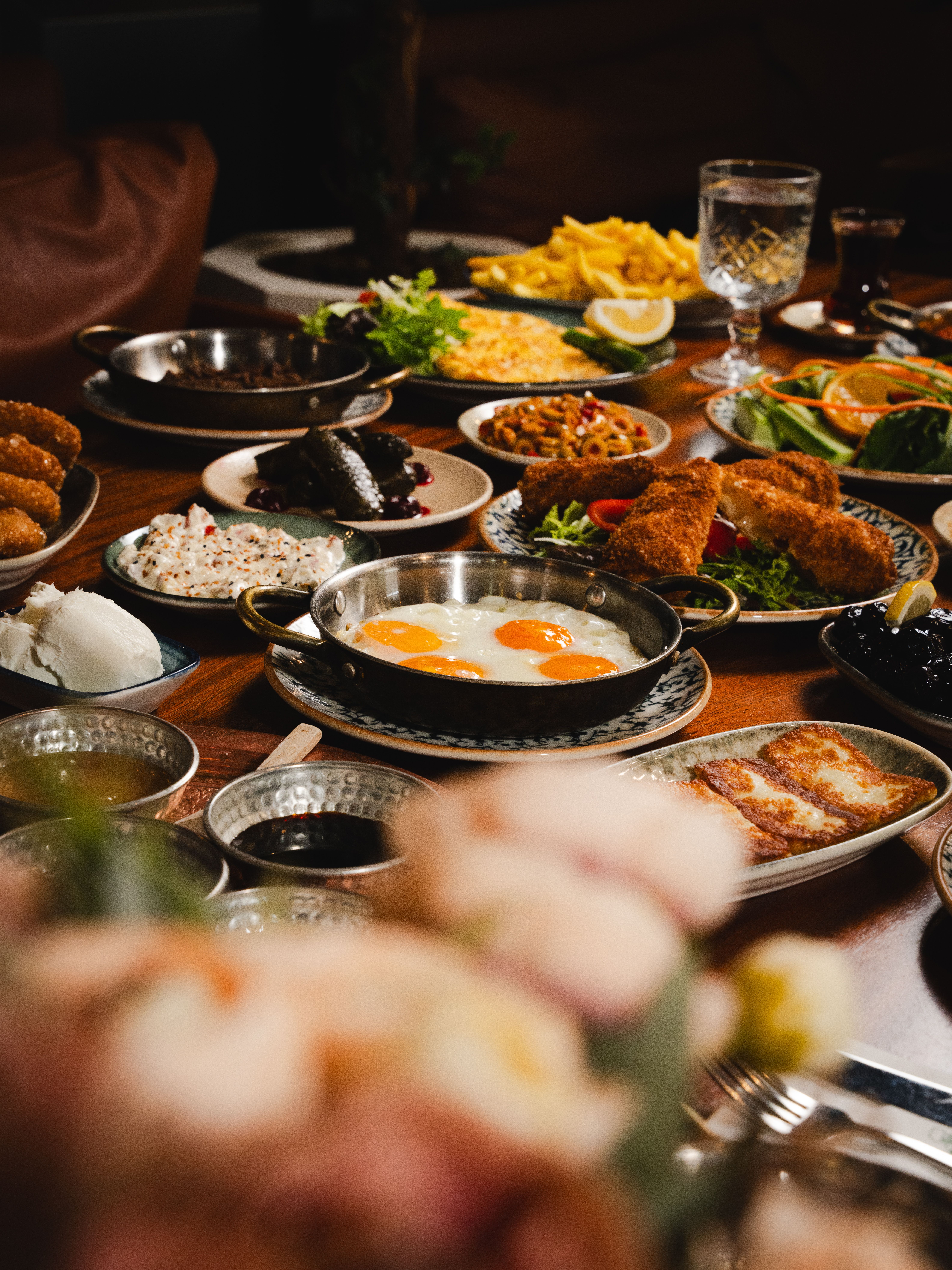 Delicious breakfast spread featuring eggs, meats, and sides set on a beautifully arranged table.