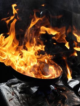 Fiery wok cooking with vibrant flames enhancing a dynamic culinary scene.