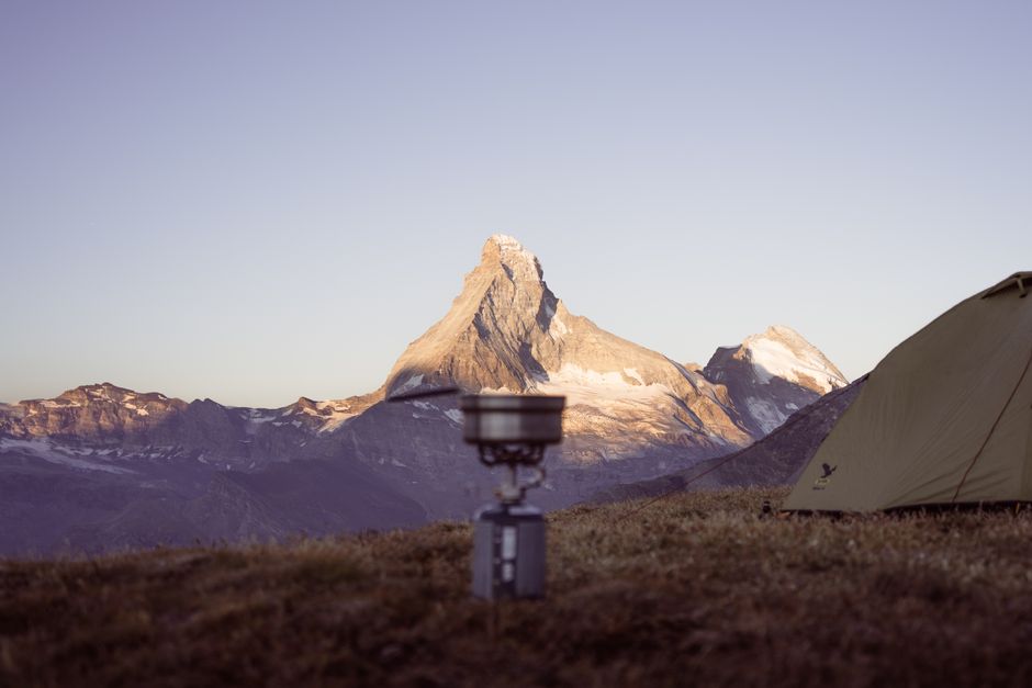 Capture of a tranquil camping scene with a view of the majestic Matterhorn during sunrise.