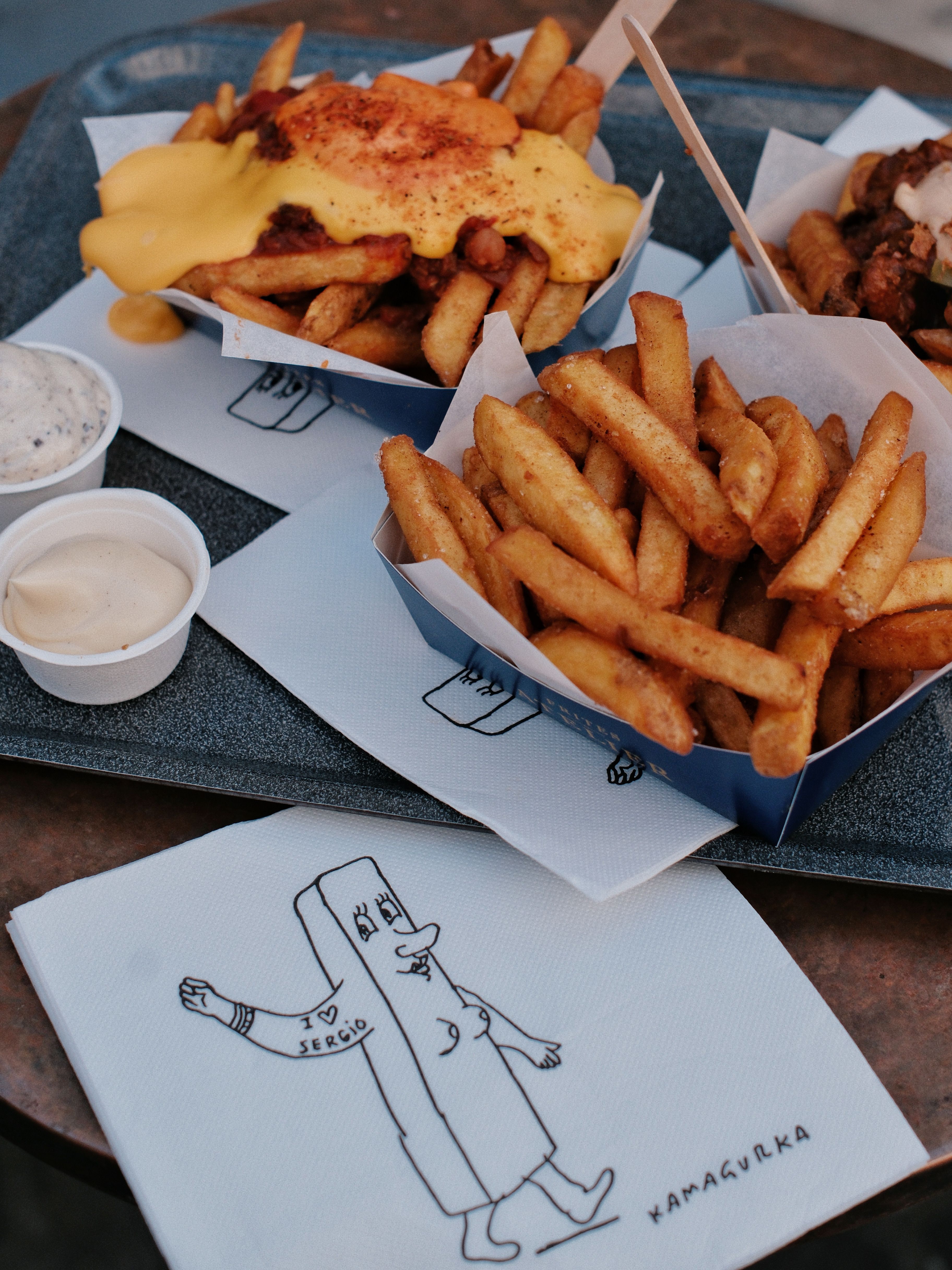 Tasty Belgium-style fries topped with melted cheese and mustard sauce, served with dips.