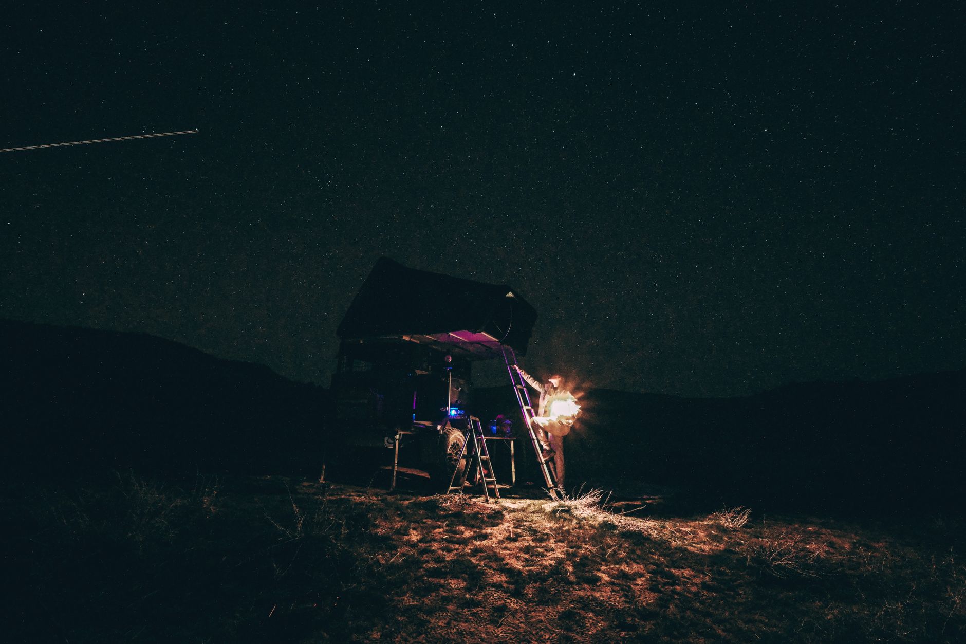 backpacker sleeping under stars wilderness