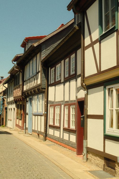 Free Quaint cobblestone street with traditional half-timbered houses in Quedlinburg, Germany. Stock Photo