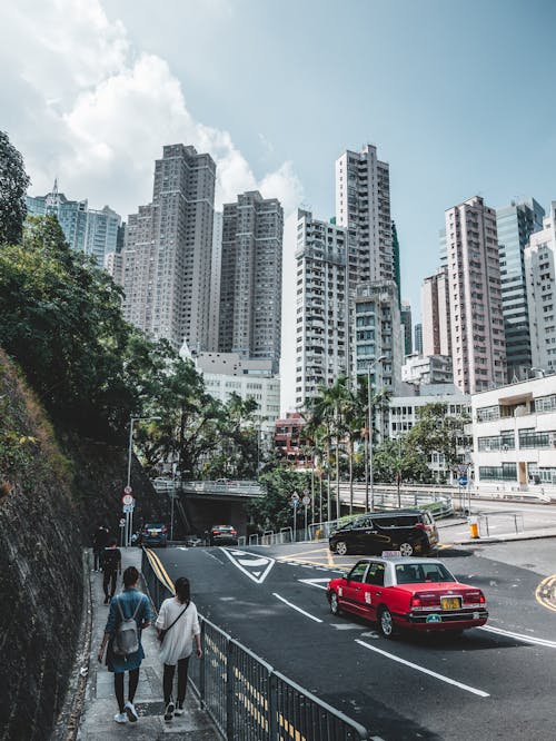 Asphalt road near modern tall buildings in city district