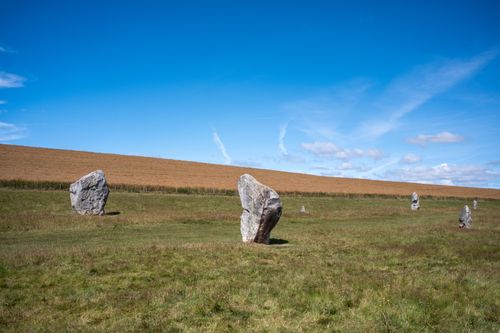 Free Explore the serene landscape of ancient stone circles beneath a bright, clear sky. Stock Photo