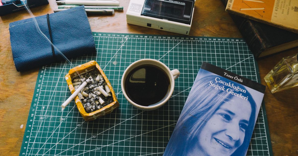 A cigarette beside a morning coffee during daily routine