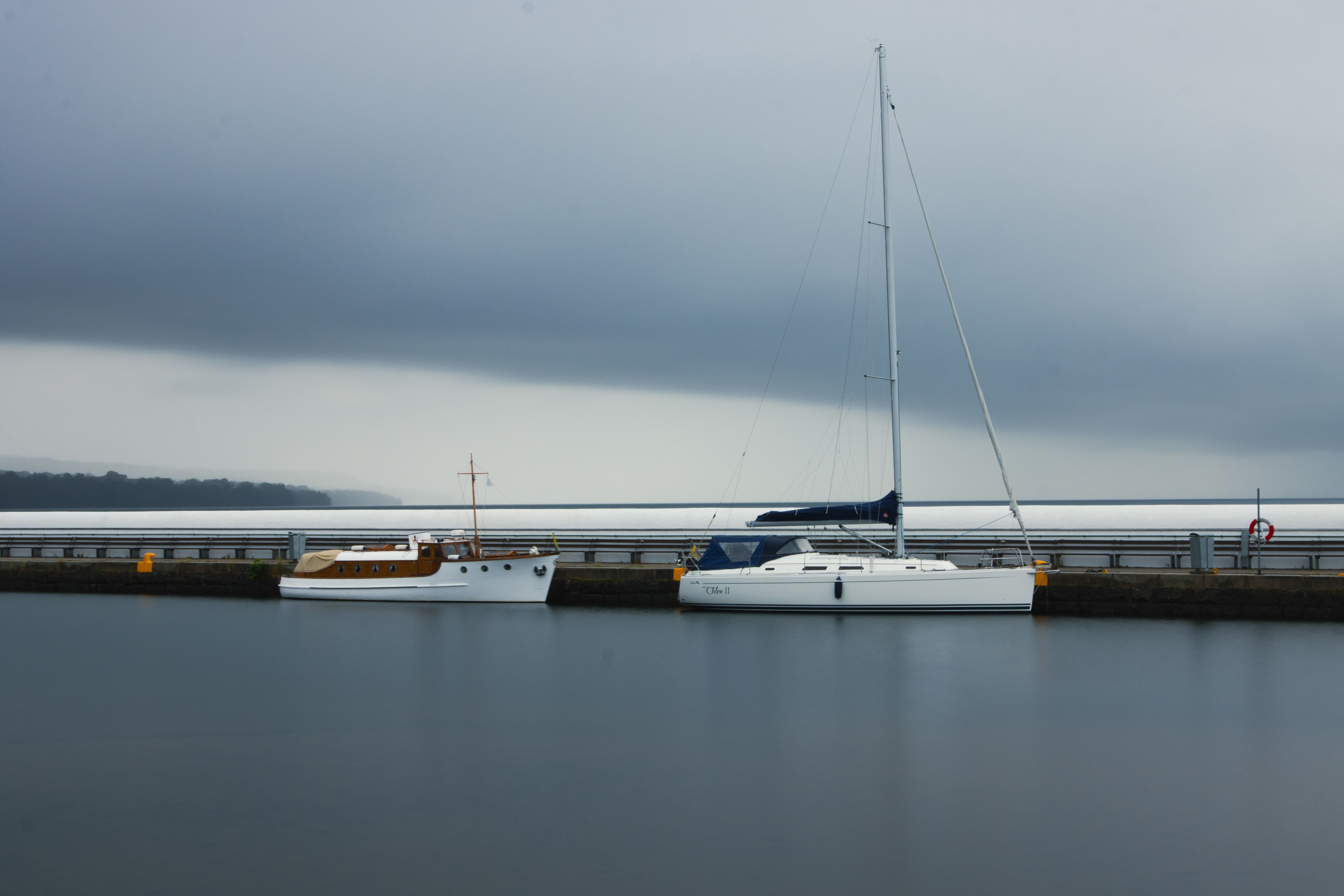Peaceful boats docked on Lake Vättern in Jönköping, Sweden, under a moody sky.