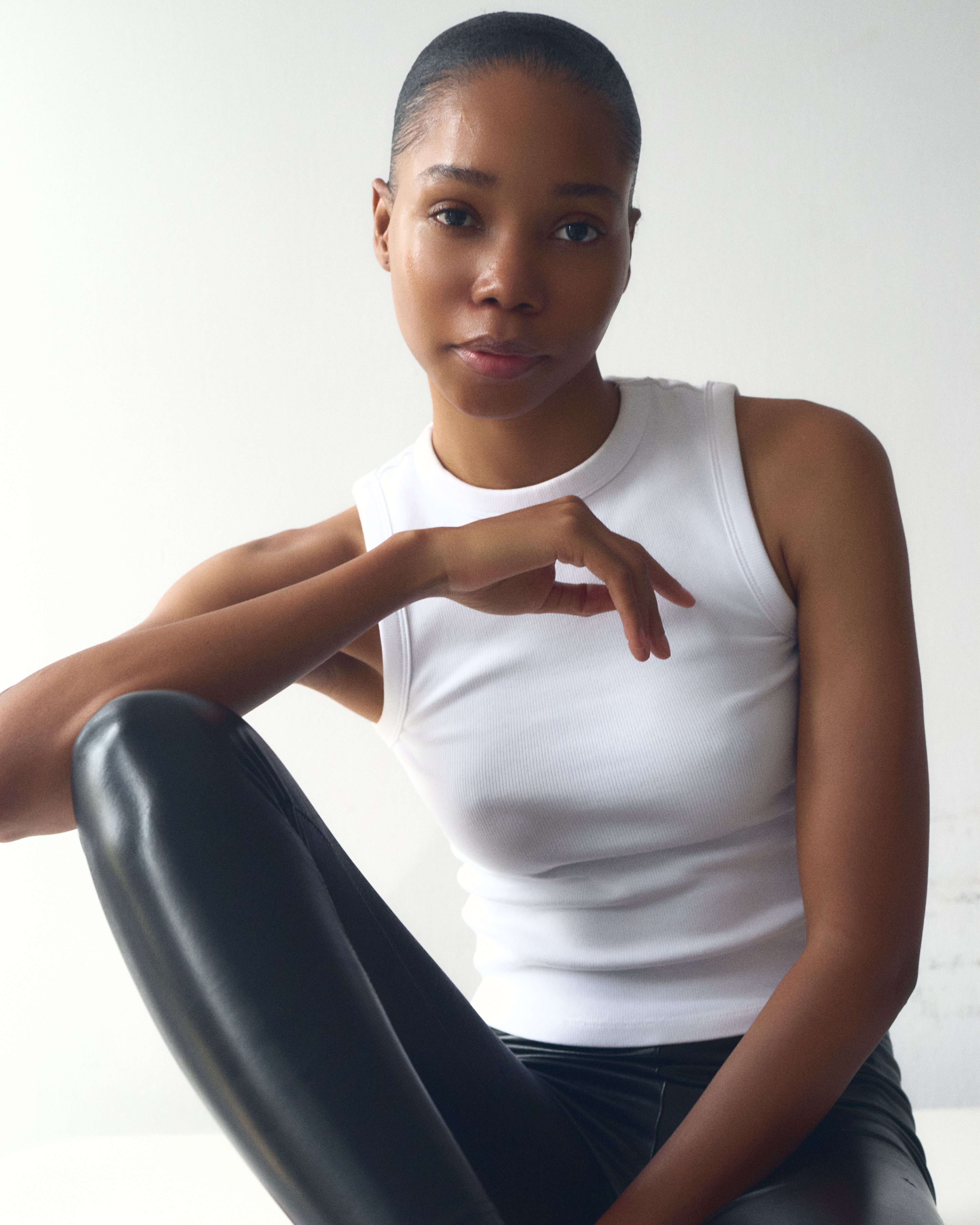 Striking portrait of a model in a minimalist setting, showcasing fashion and style.