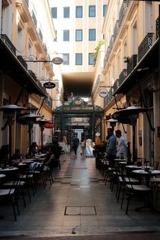 Beautiful European lane with outdoor cafes and people enjoying a vibrant atmosphere. - Fotografer Sidoarjo