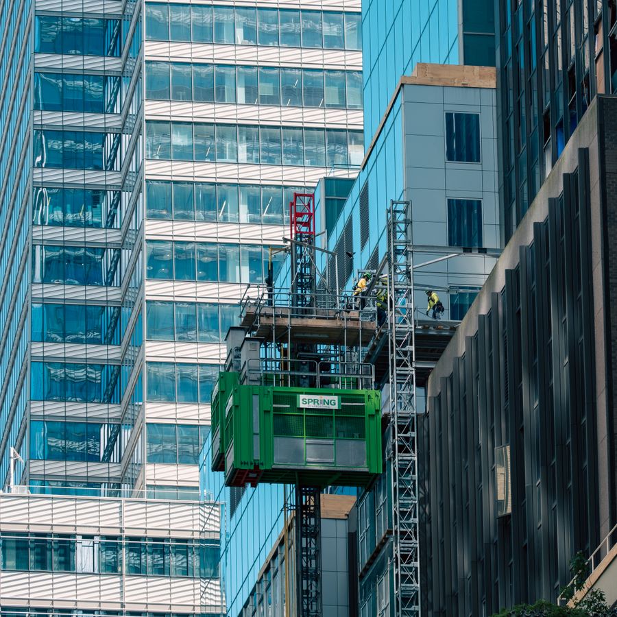 High-speed construction hoist on a glass tower