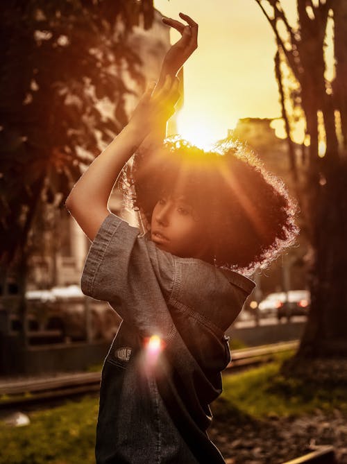 Soñadora Joven étnica Bailando En El Parque De La Ciudad Durante La Puesta Del Sol
