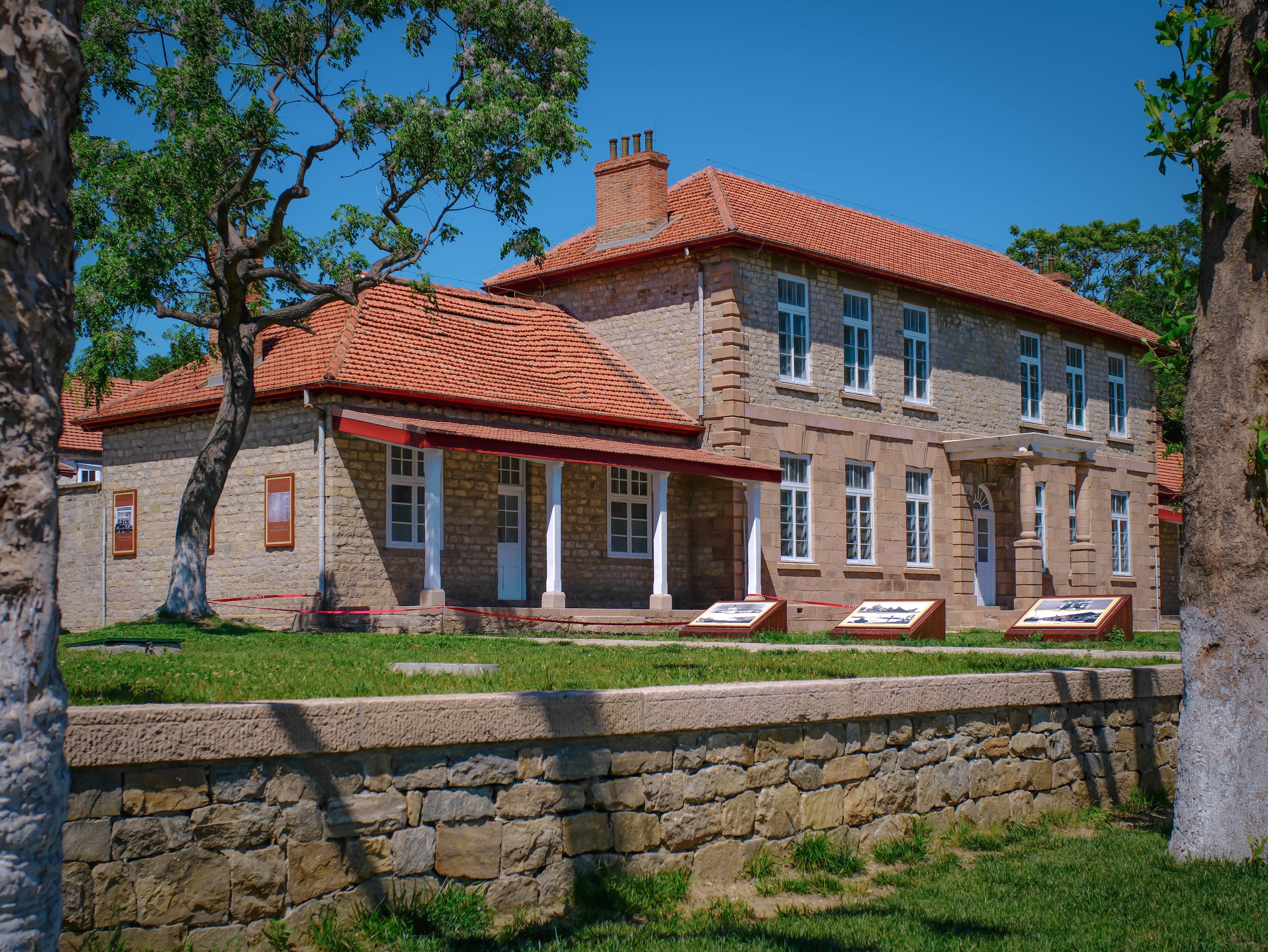 Stone farmhouse with tiled roof and lawn at the Karen Blixen Museum below the Ngong Hills