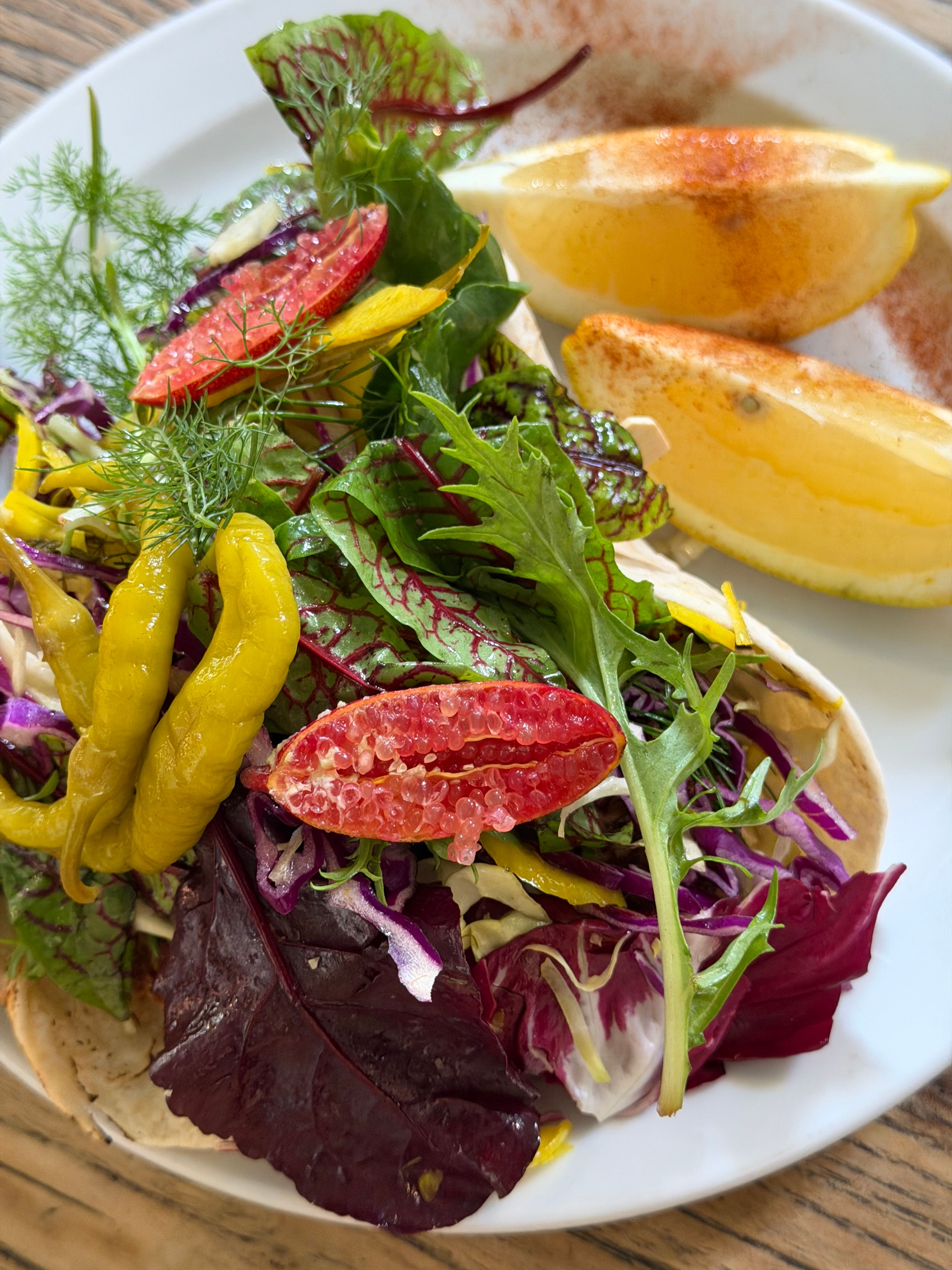 Vibrant vegetarian dish with leafy greens, citrus and spices, ideal for healthy diets.