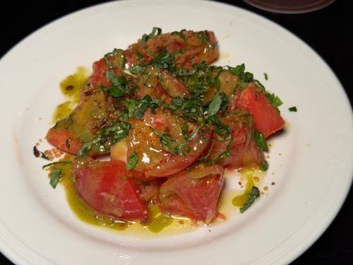 Free Delicious tomato salad drizzled with olive oil and fresh herbs, perfect for summer meals. Stock Photo